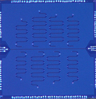 Photograph of VTT’s typical CPW resonator test chip, with eight 4 to 8 GHz resonator coupled weakly to a common feedline.